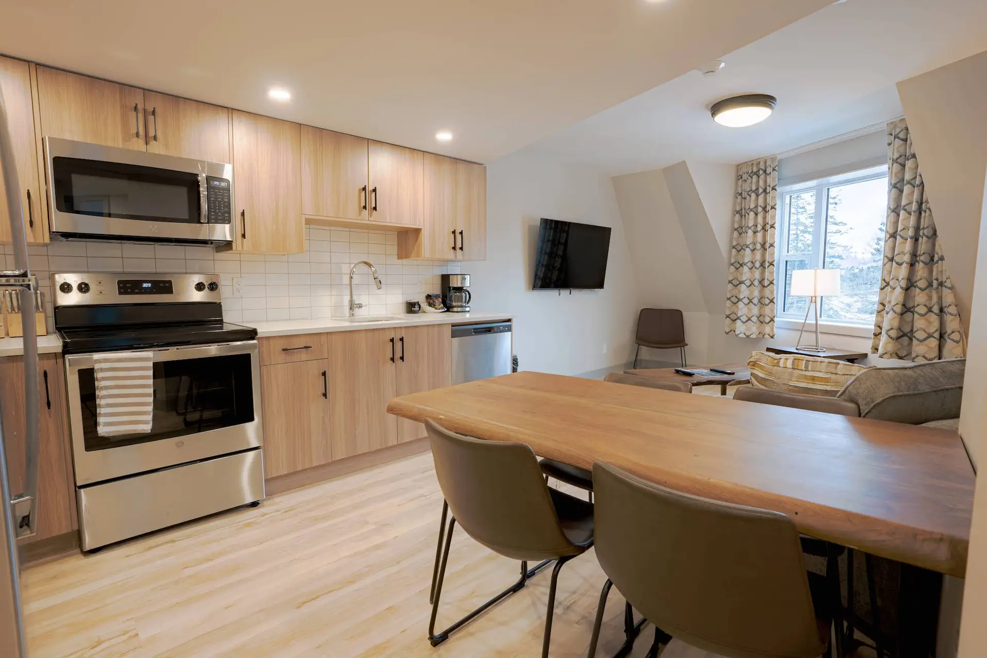 Modern kitchen and living area of a Basecamp Suites Banff Superior Two Bedroom Suite.