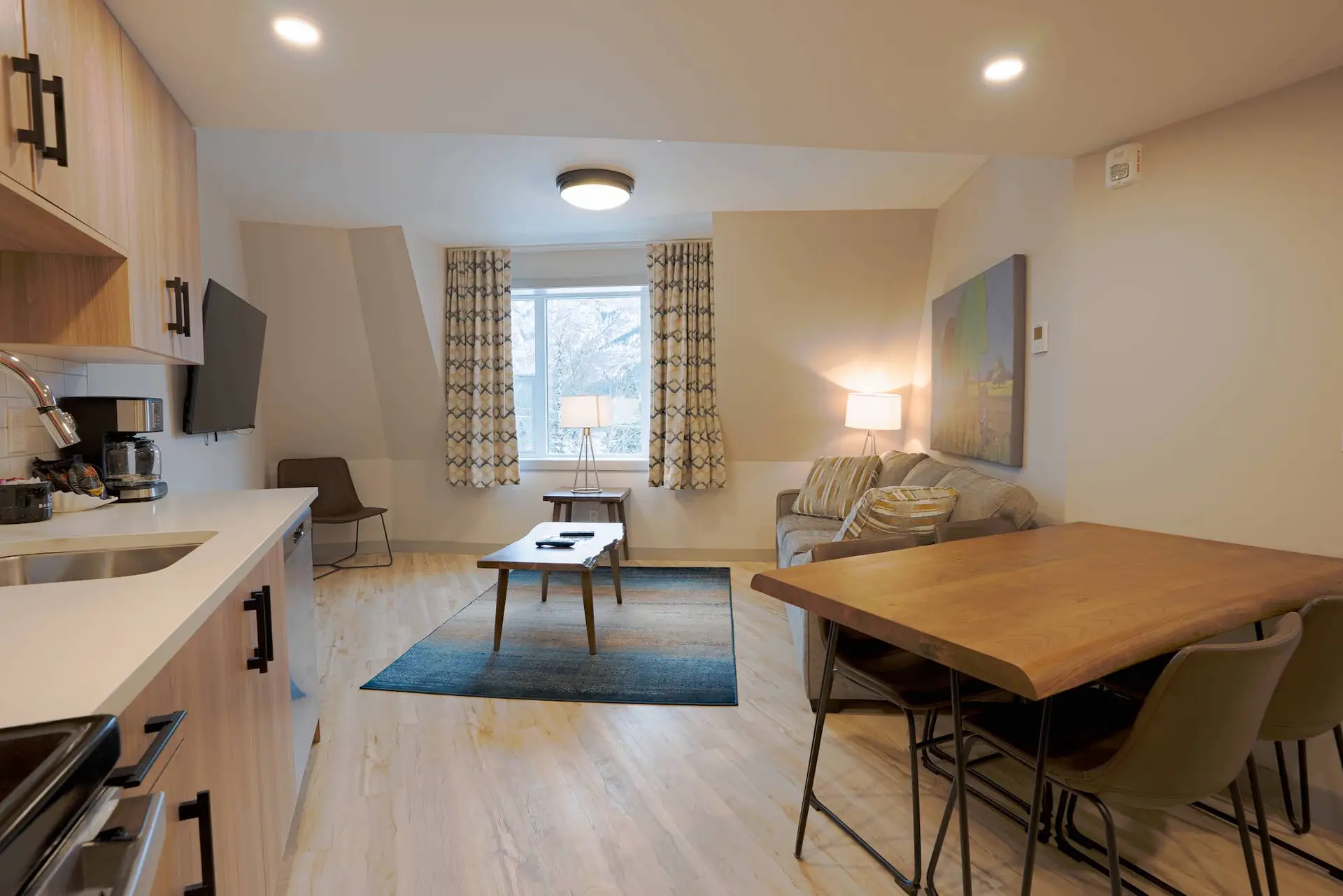 Basecamp Suites Banff: Living area and kitchenette in a superior two-bedroom suite.
