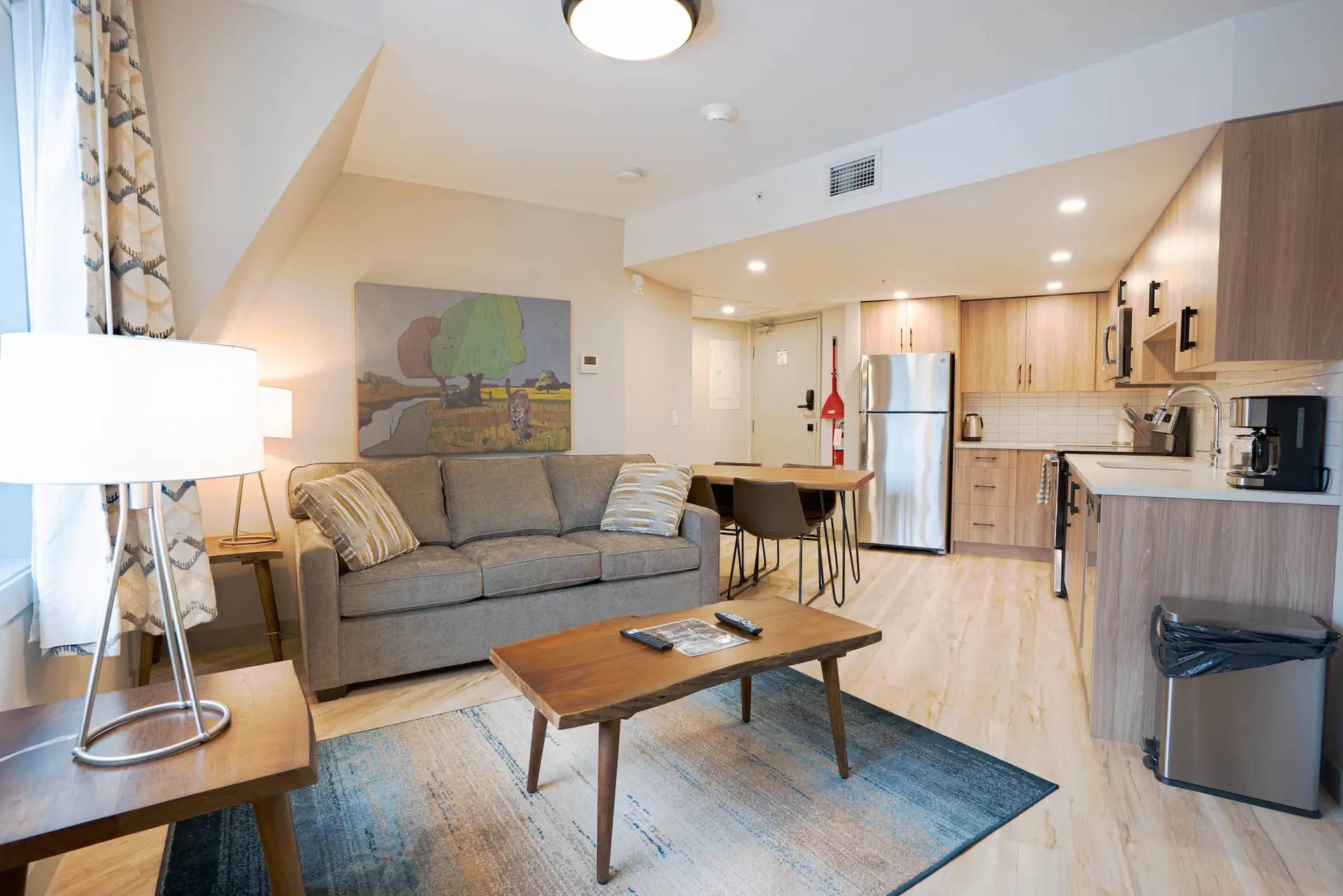 Basecamp Suites Banff Superior Two Bedroom Suite living area with sofa, coffee table, and kitchen.