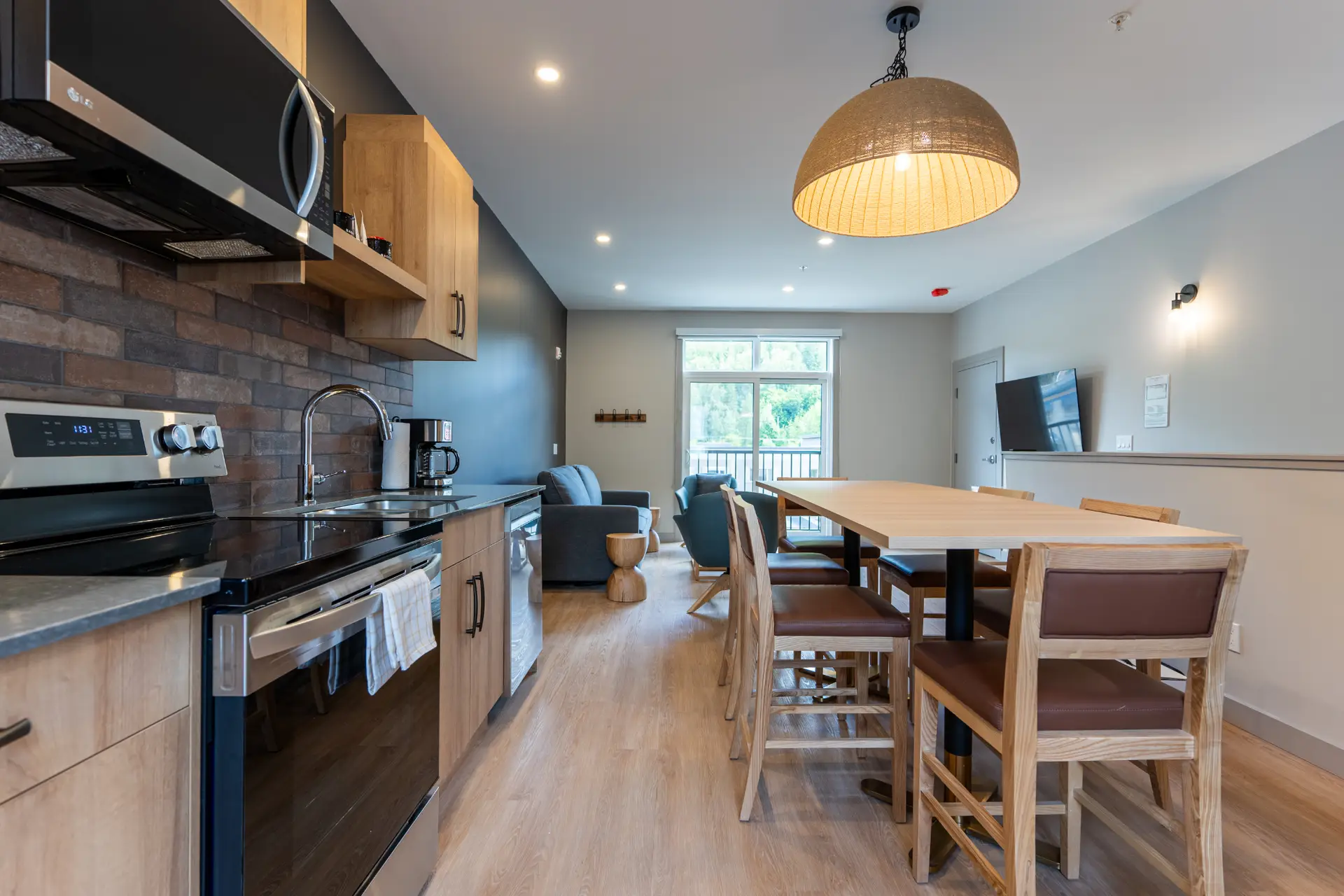 Modern kitchen and dining area in a Basecamp Suites Revelstoke two-bedroom suite.