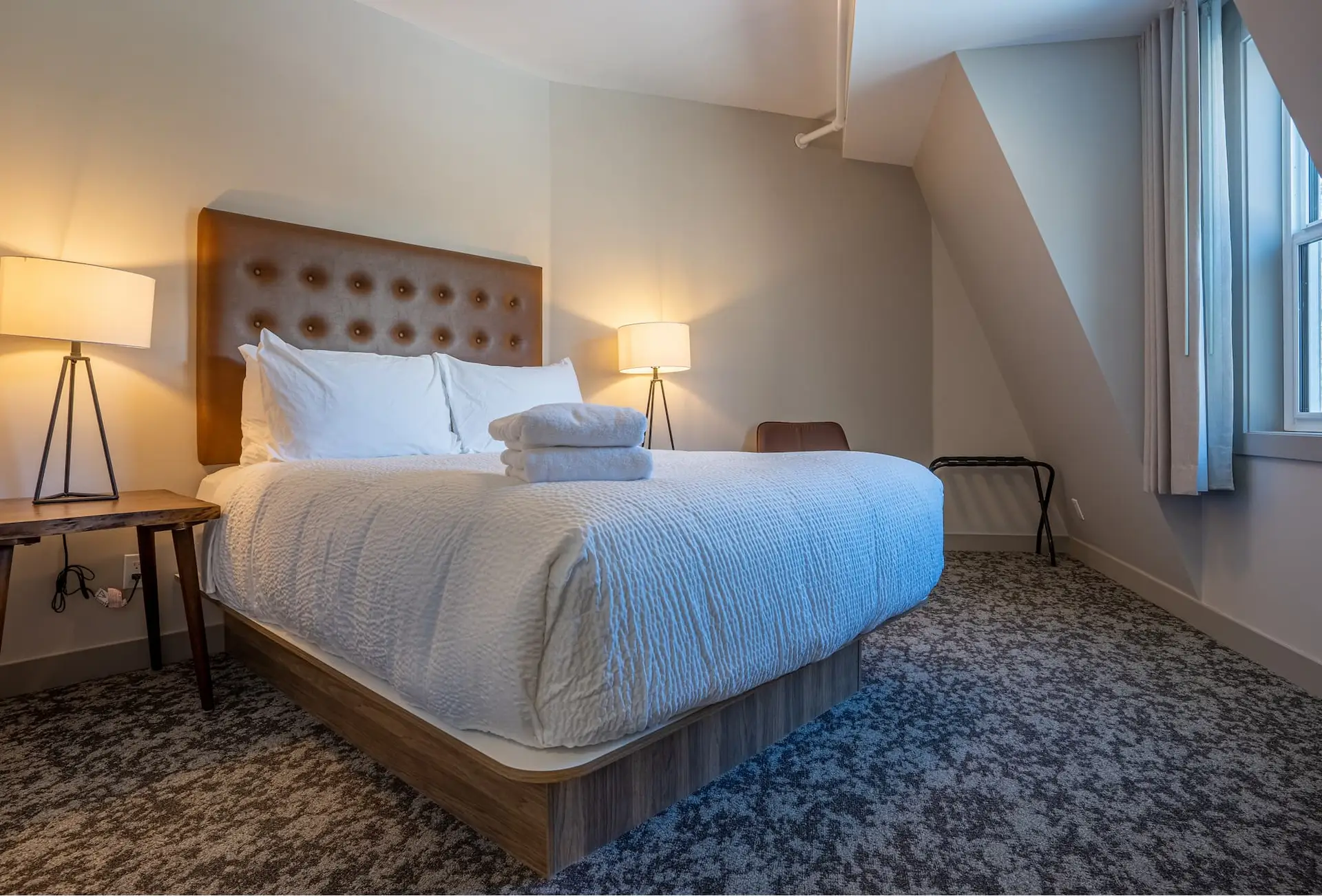 King-sized bed in a modern hotel room at Basecamp Suites Banff