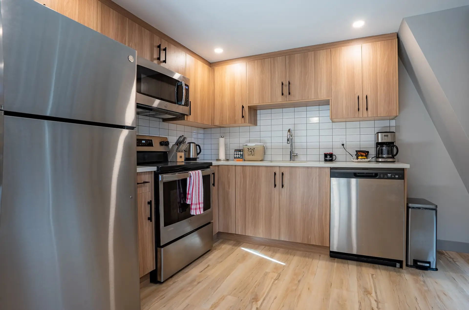 Modern kitchen in Basecamp Suites Banff three bedroom suite with stainless steel appliances.