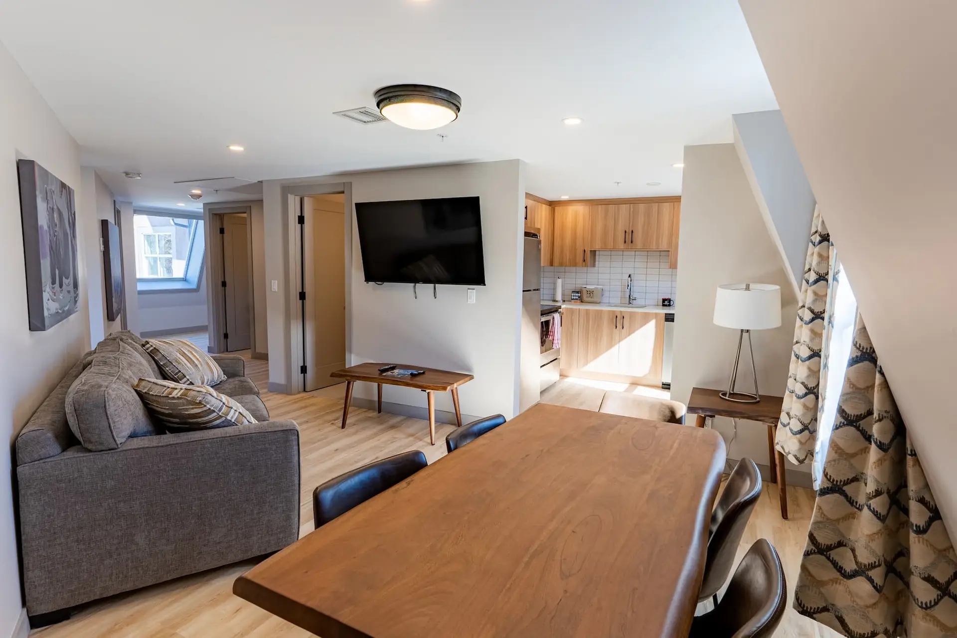 Living area and kitchen of a Basecamp Suites Banff three bedroom suite