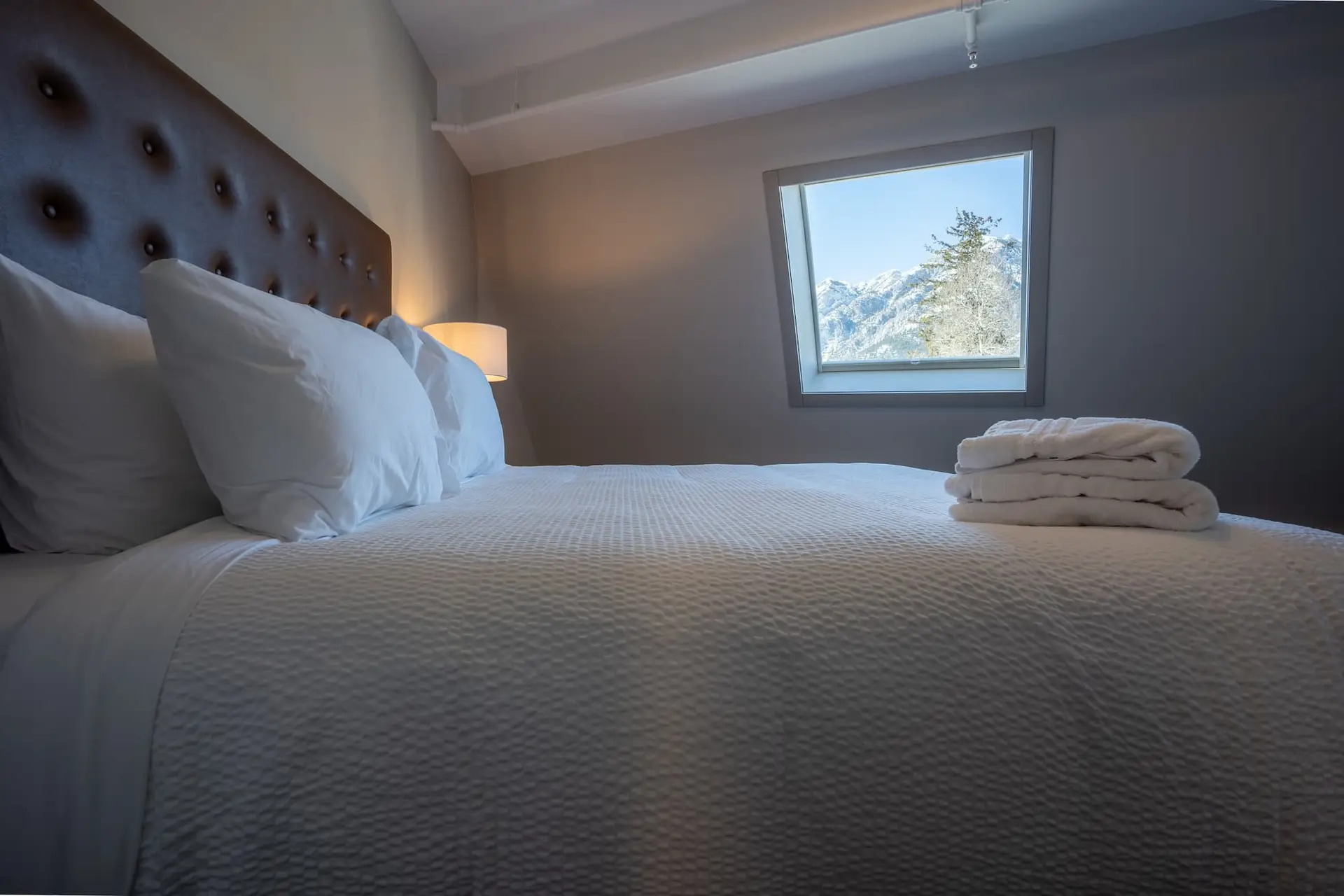 Cozy bedroom in Basecamp Suites Banff with mountain view.