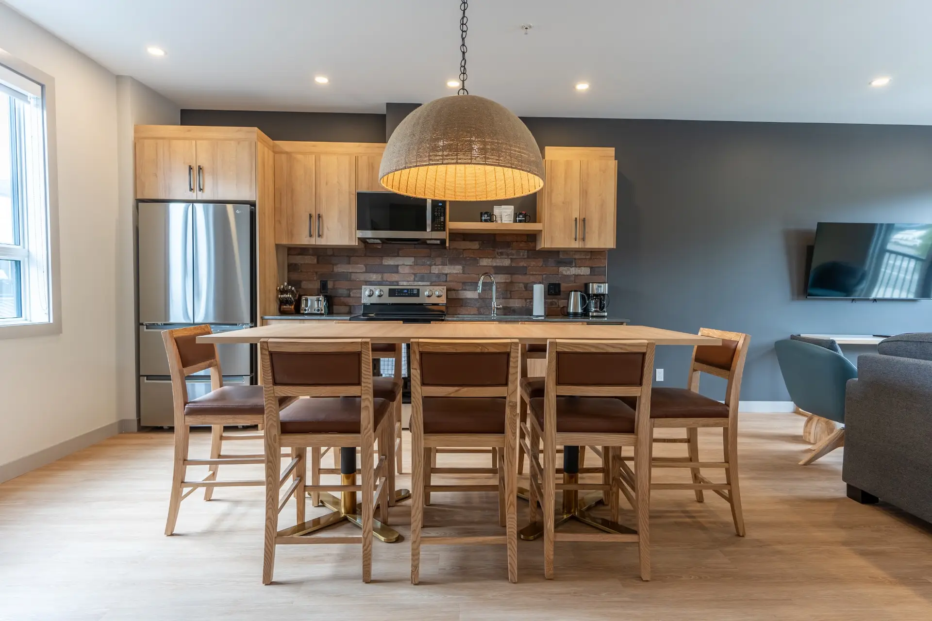 Modern kitchen and dining area in a Basecamp Suites Revelstoke three bedroom suite.