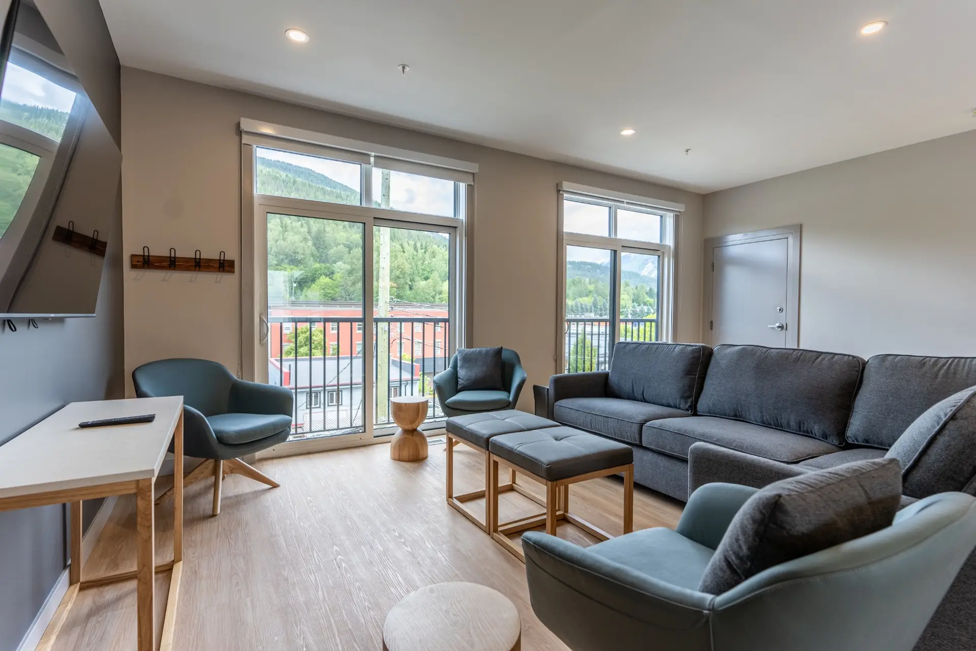 Modern living room in Basecamp Suites Revelstoke three-bedroom suite with mountain views.