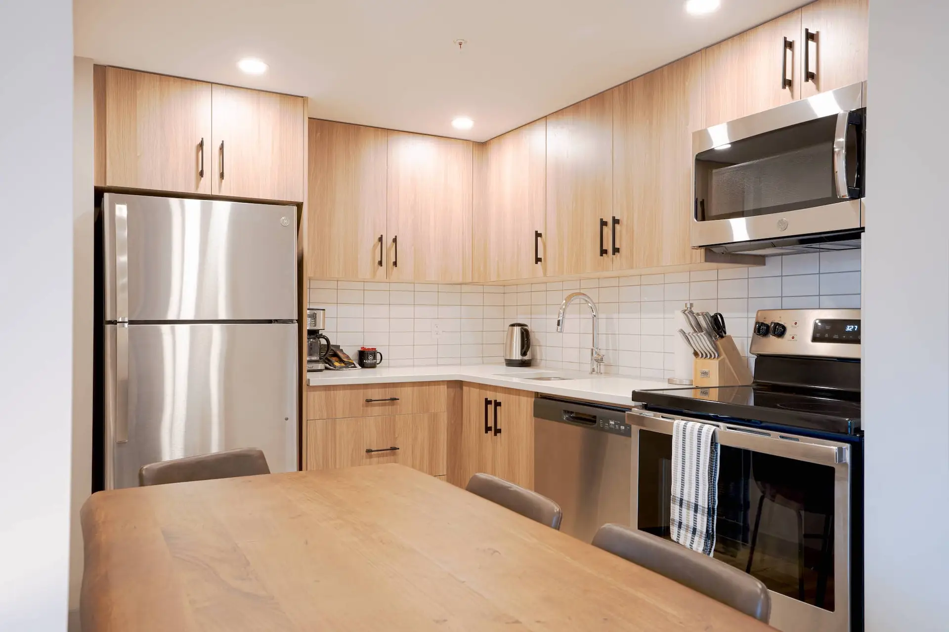 Modern kitchen in Basecamp Suites Banff two bedroom suite with stainless steel appliances.