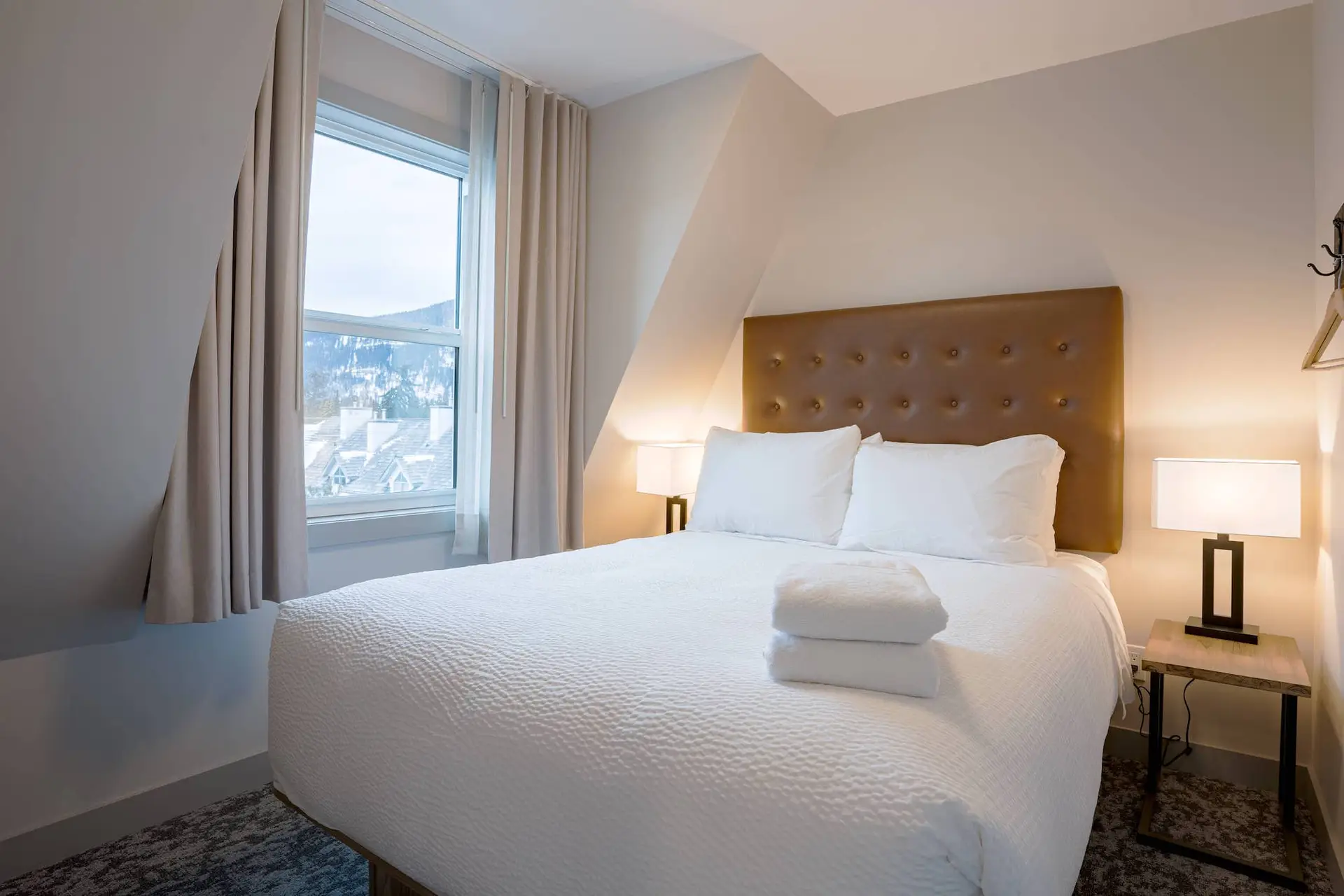 Banff Two Bedroom Suite: Queen bed with white linens and mountain view