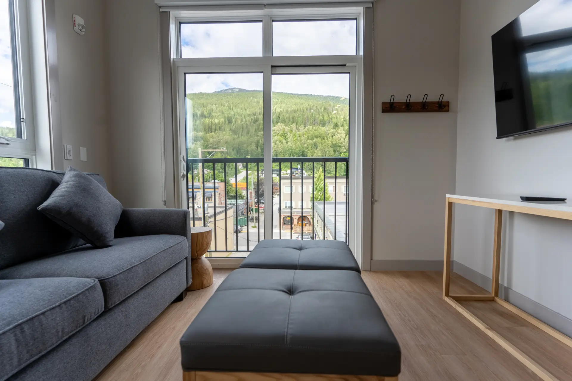 Basecamp Suites Revelstoke two-bedroom suite living area with mountain view
