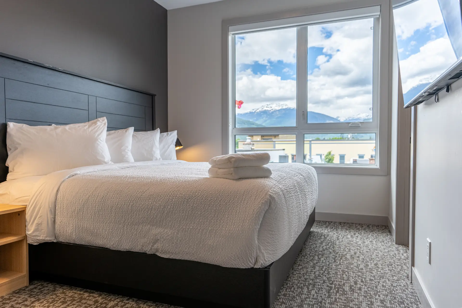 King bed in Basecamp Suites Revelstoke two-bedroom suite with mountain view