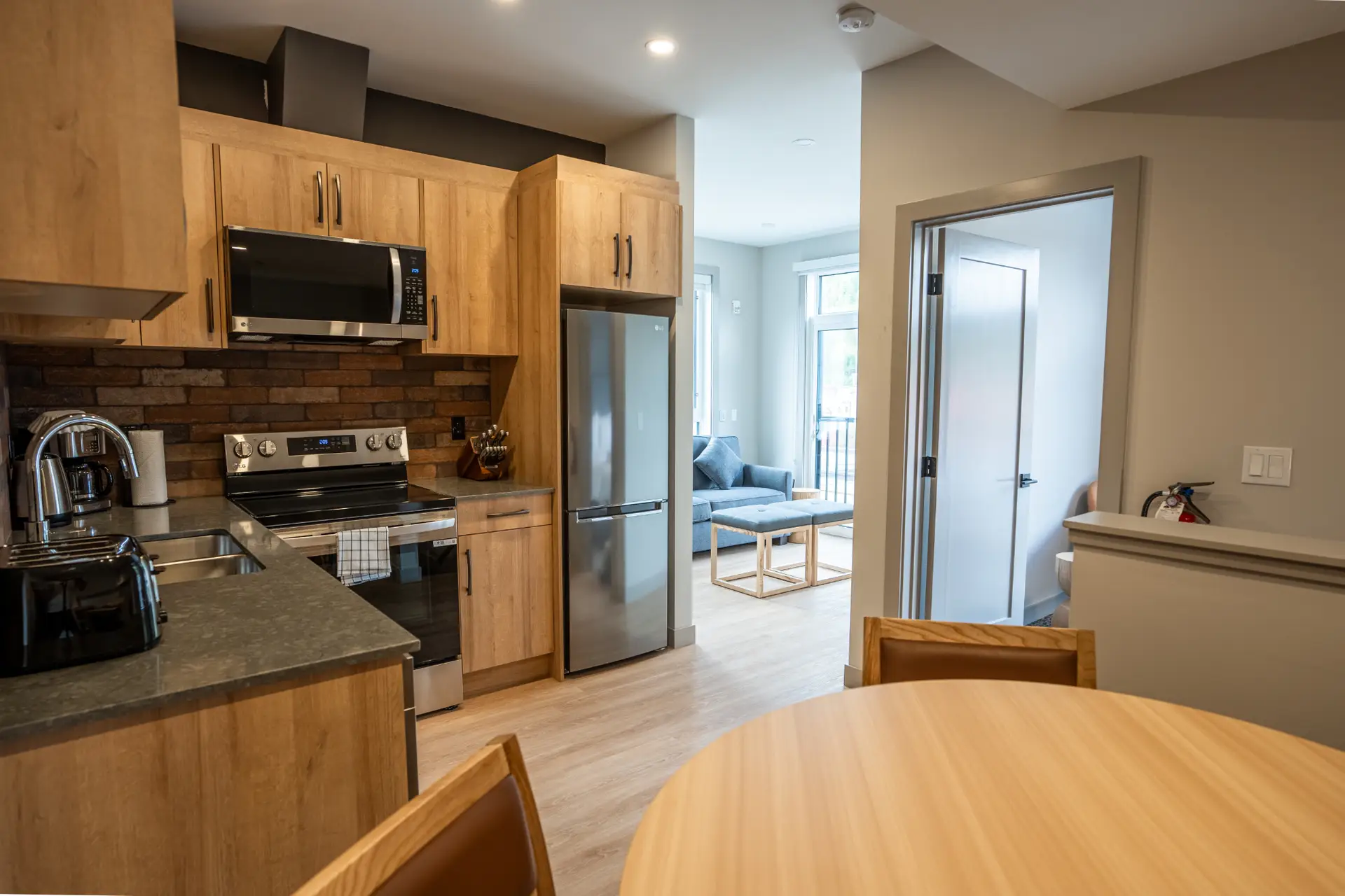 Basecamp Suites Revelstoke two-bedroom suite kitchen and living area.