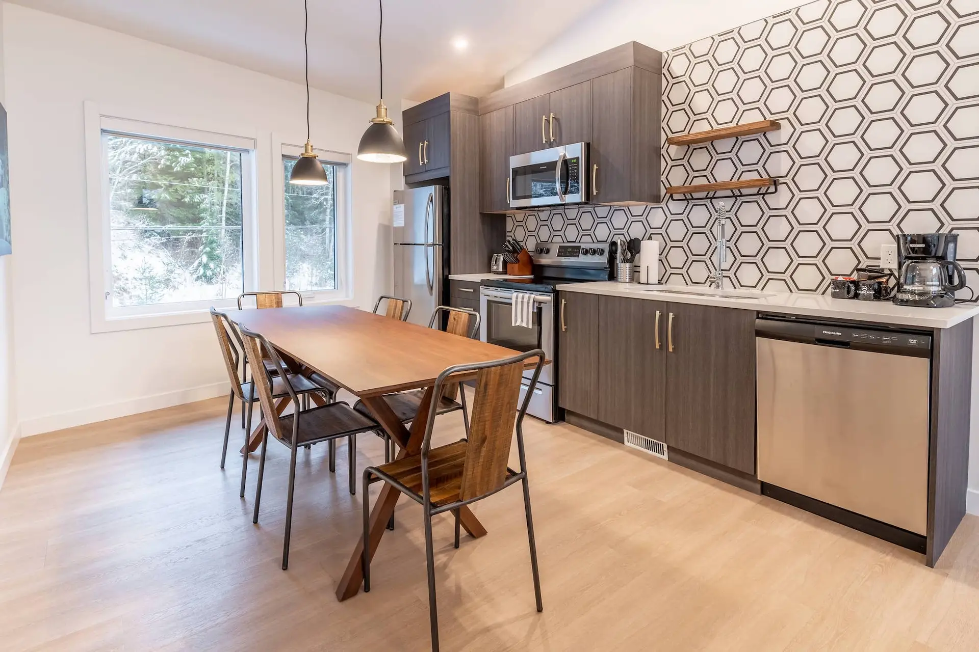 Revelstoke two bedroom suite kitchen and dining area with modern finishes.