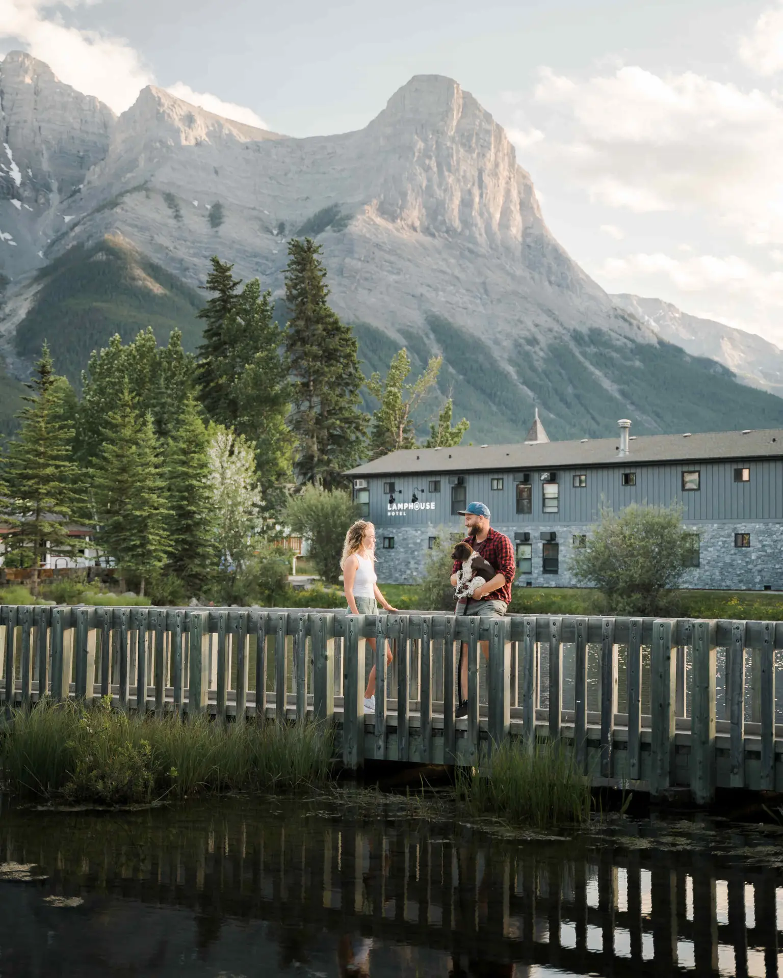 Couple on bridge at Lamphouse Hotel with mountain backdrop