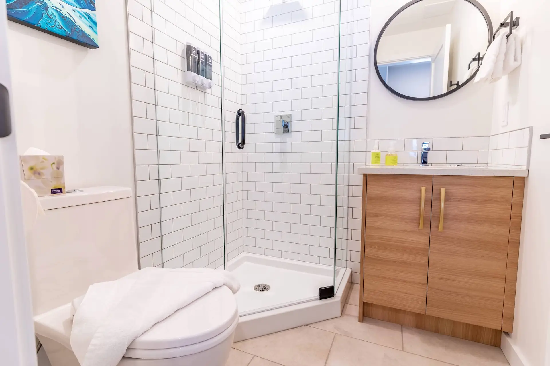 Modern Revelstoke micro studio bathroom with white subway tile shower and wood vanity