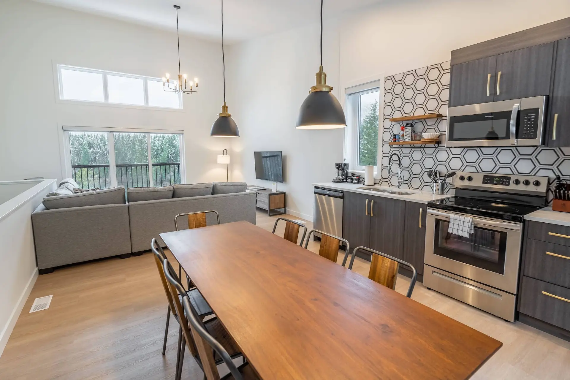 Basecamp Resorts Revelstoke Four Bedroom Suite open floor plan with dining table and kitchen