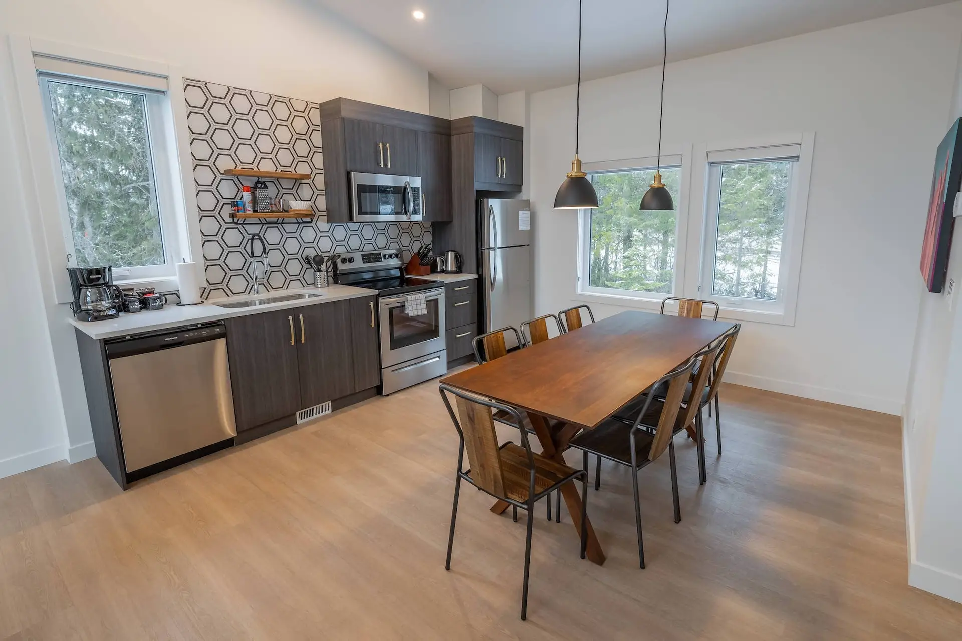 Modern kitchen and dining area in a Basecamp Resorts Revelstoke suite.