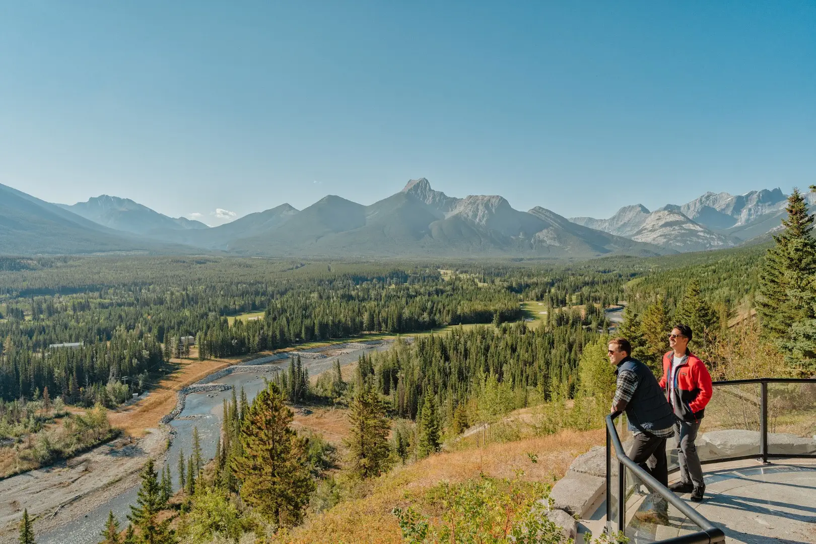 Kananaskis: Two men enjoying a scenic mountain and forest view.