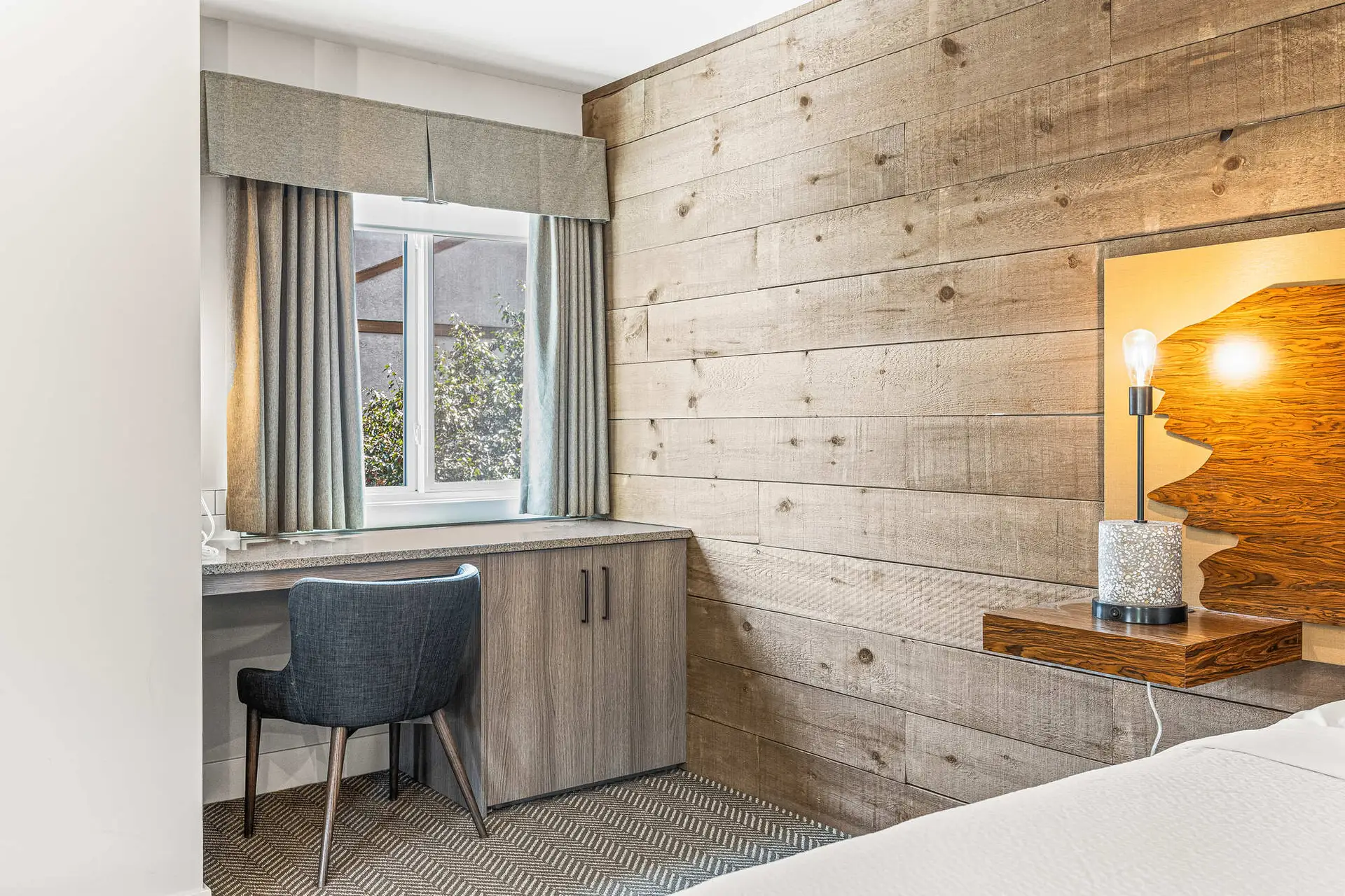 Basecamp Lodge Canmore King Suite: desk, window, and wood-paneled wall