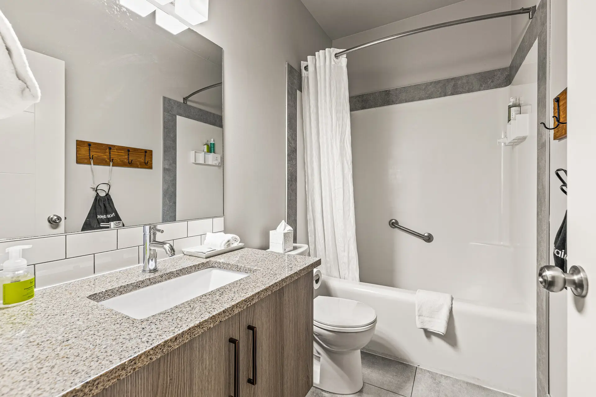 Basecamp Lodge Canmore double queen room bathroom with sink, toilet, and shower.