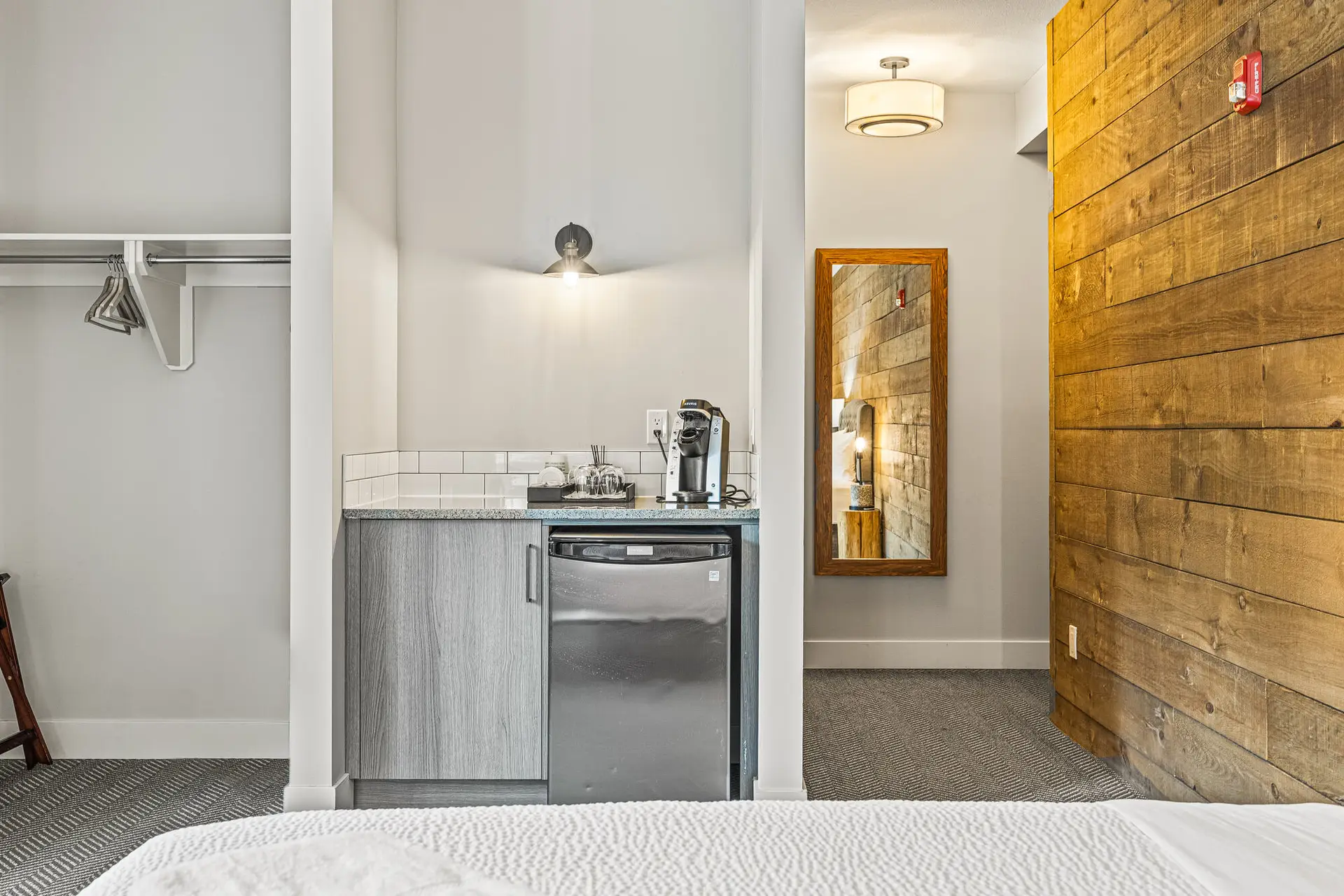 Double Queen room at Basecamp Lodge Canmore: mini-kitchen with Keurig, fridge, and closet