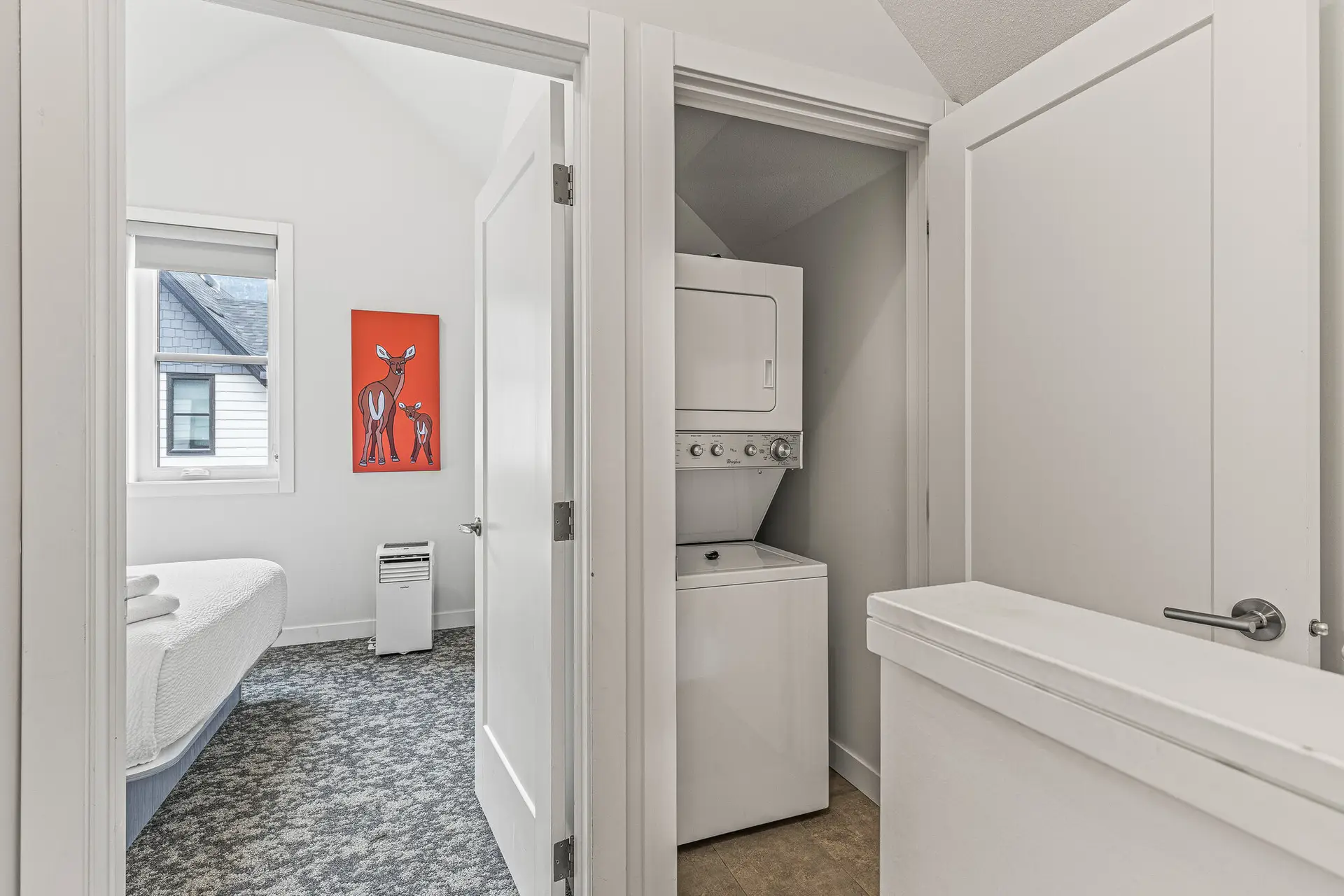 Basecamp Resorts Canmore Two Bedroom Suite: Laundry area with stacked washer and dryer.