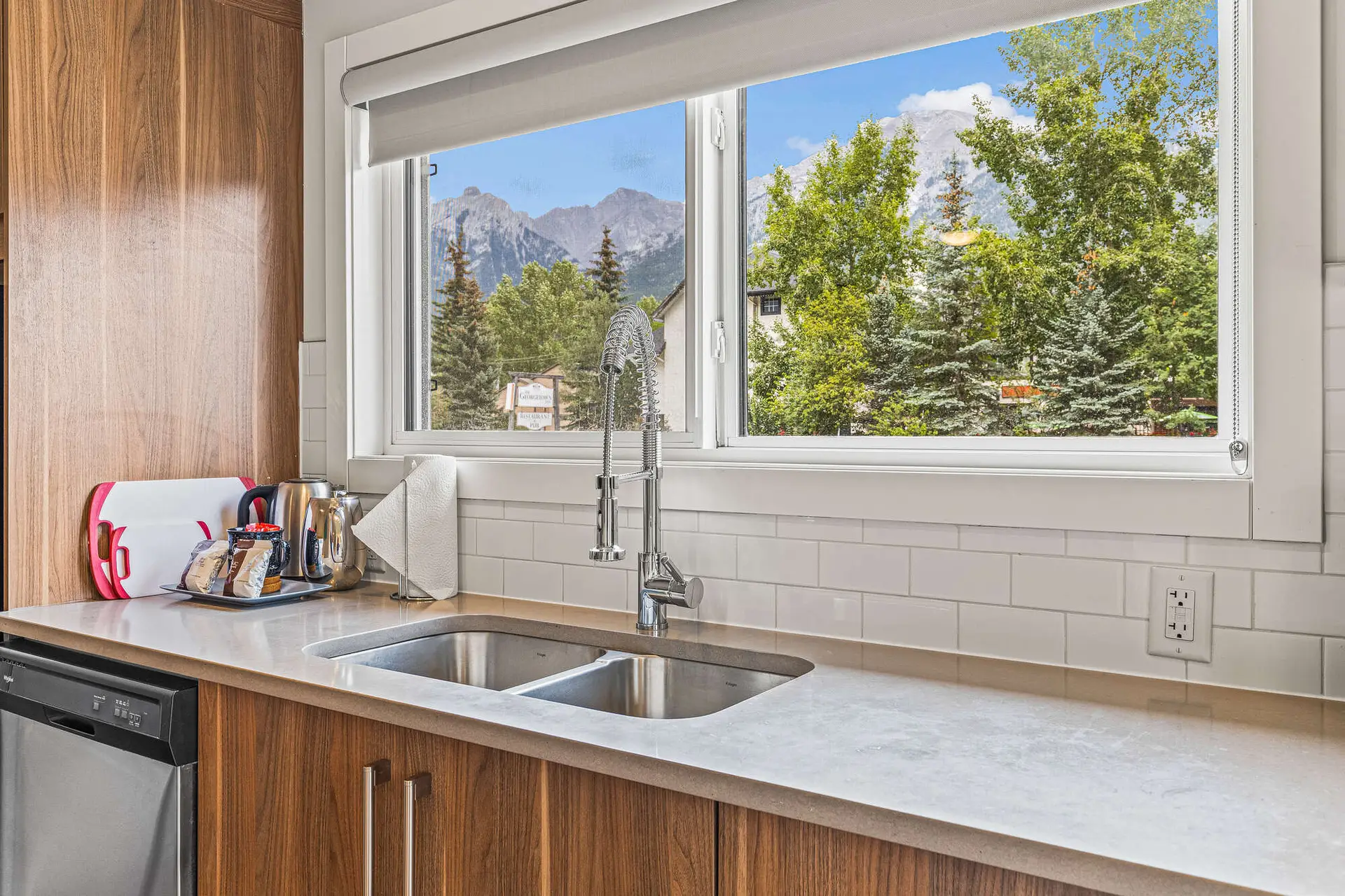 Canmore micro studio kitchen with mountain view from window.