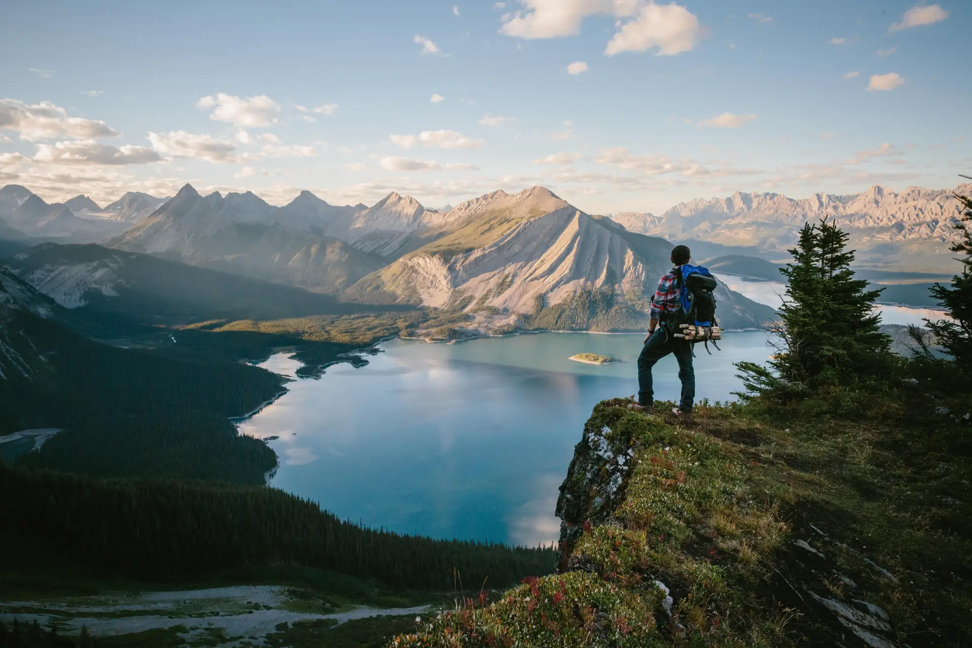 Hiker overlooks stunning Kananaskis lake and mountains, one of the best hikes.