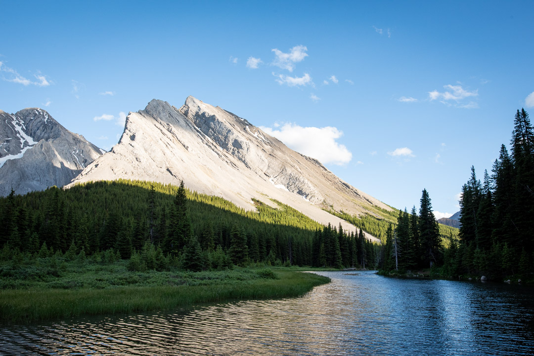 Scenic Kananaskis landscape with mountains, pine forest, and a winding river, ideal for best hikes Kananaskis.