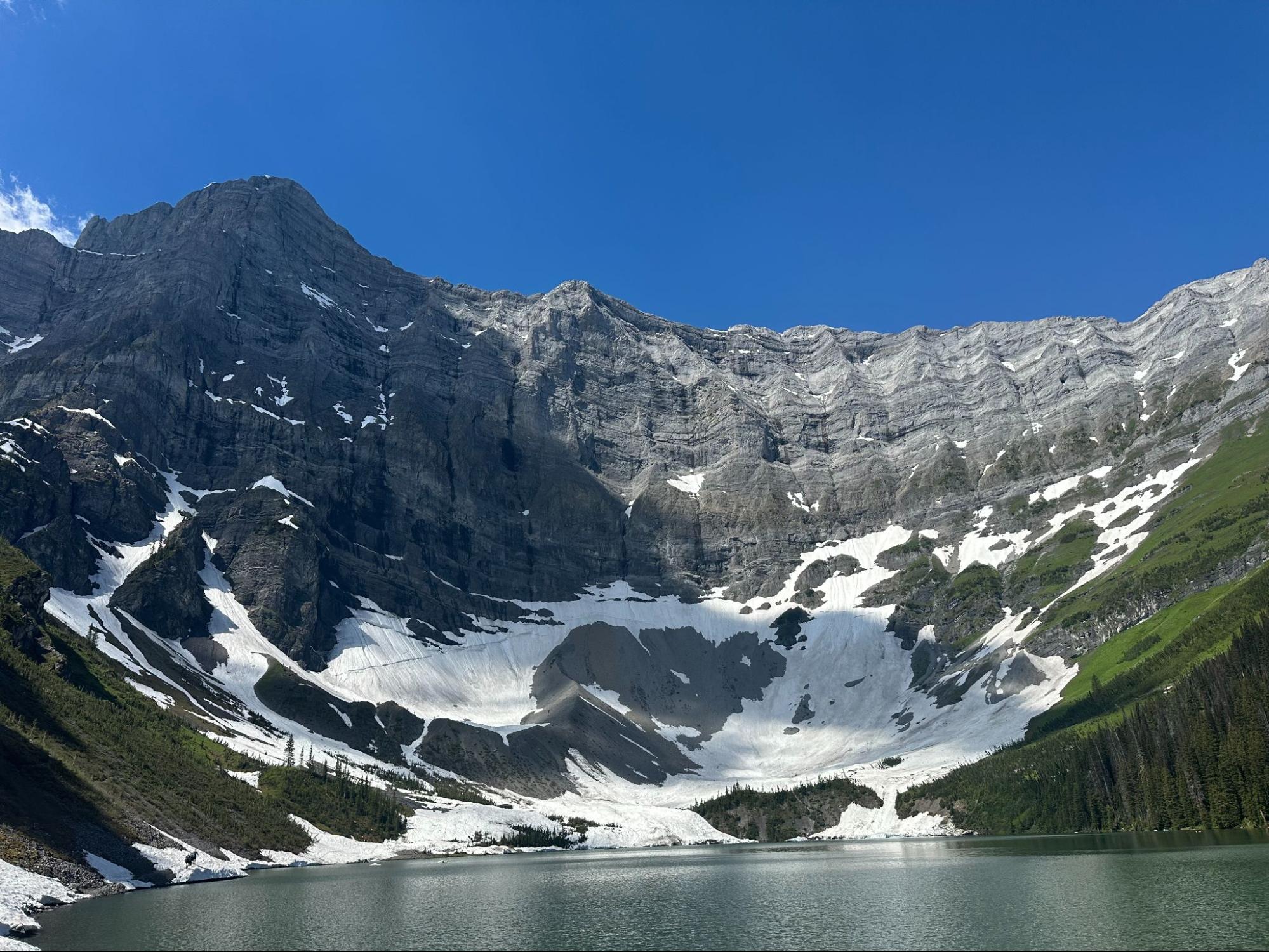 Snowy cirque lake and mountain in Kananaskis, a top summer hike destination.