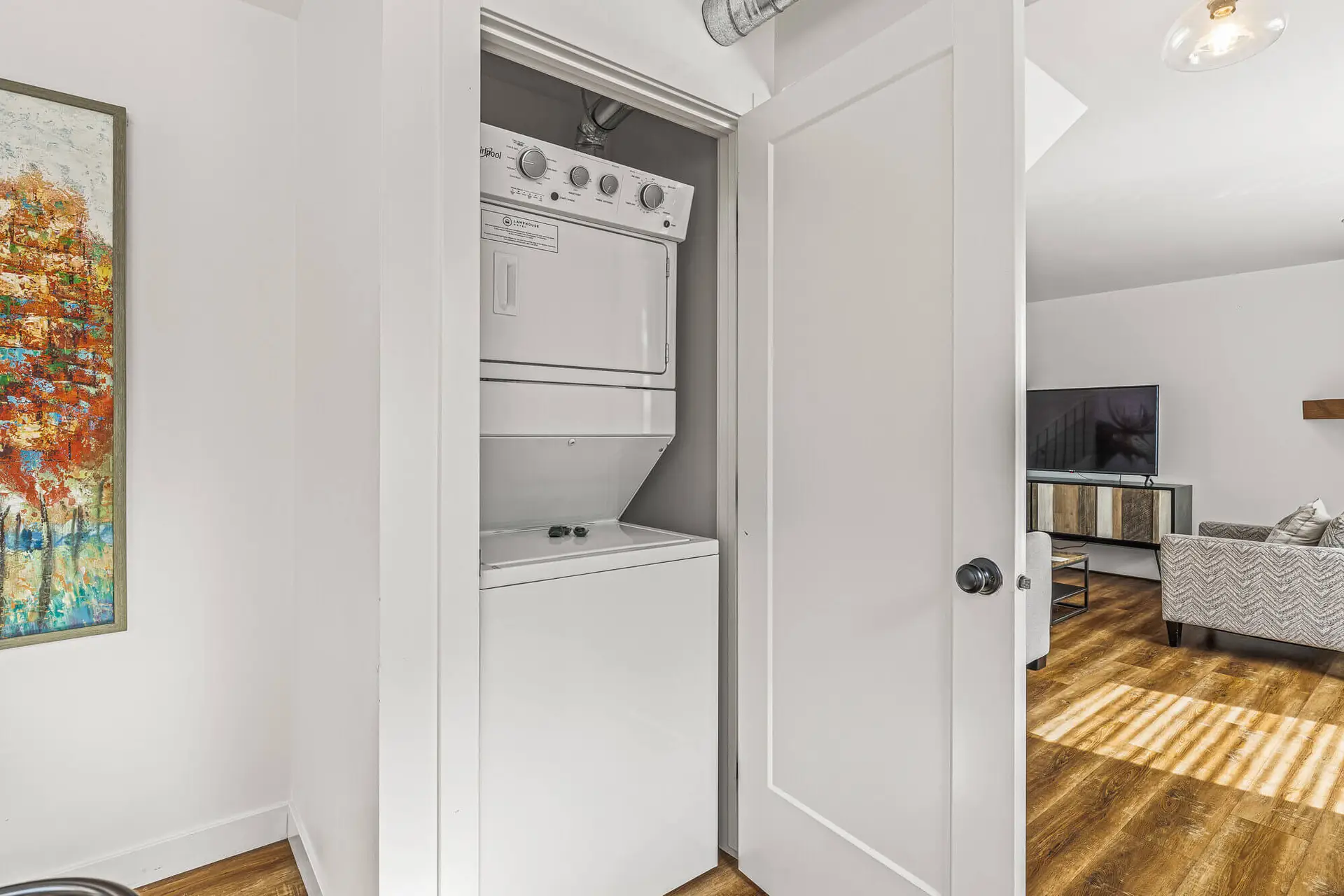 Stacked washer dryer unit in a closet at Basecamp Lamphouse Canmore