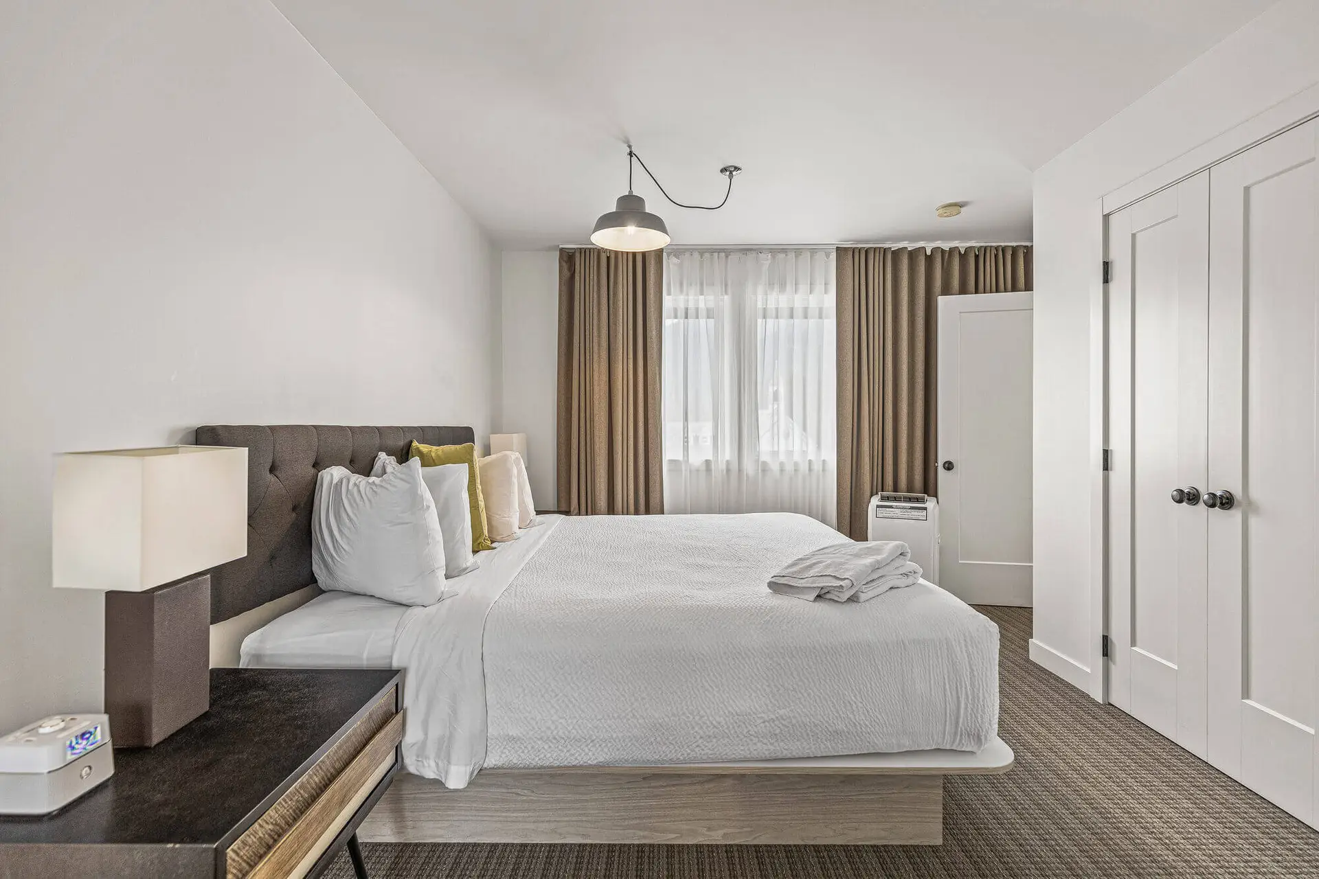 Basecamp Lamphouse Canmore apartment bedroom with king bed and modern decor